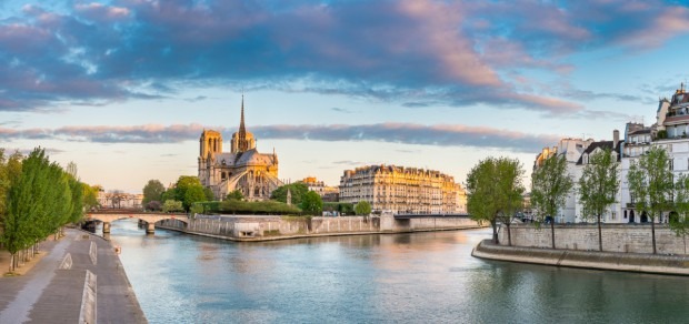 Notre Dame Cathedral on the banks of the Seine River at sunrise