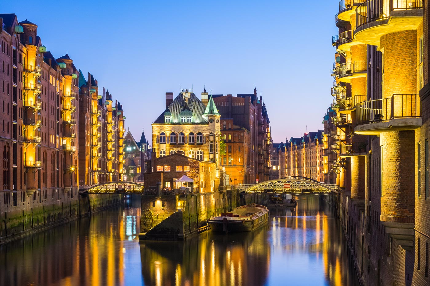 View of Wasserschloss at night from Poggenmuhlebrucke in Speicherstadt, Hamburg