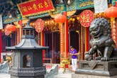 Man praying in front of main altar house of Wong Tai Sin (Sik Sik Yuen) Temple, Hong Kong
