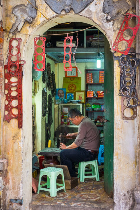Vietnamese man working in his shop in Hanoi, Vietnam