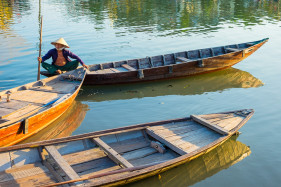 Vietnamese woman in a small boat on the Thu Bồn River, Hoi An, Quang Nam Province, Vietnam