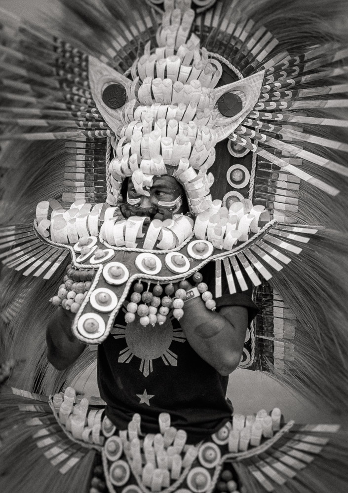 A participant in the Ati-atihan parade wearing a hand-made-made costume made from natural and salvaged materials. Ati-Atihan festival in honor of Santo Niño takes place yearly in Kalibo, Aklan, Western Visayas, Philippines.