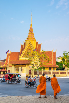 Two monks cross the street in front of the Cambodian Supreme Court, Phnom Penh, Cambodia