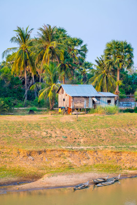 Houses and dugout canoes on the bank of the Stung Saen River, Krong Stueng Saen, Kampong Thom Province, Cambodia