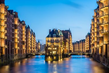 Germany, Hamburg, Speicherstadt. Historic Wasserschloss at dusk, view from the Poggenmuhlenbrucke.